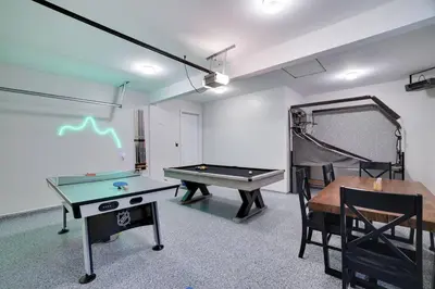 a room with a ping pong table and a ping pong ball at Cozy Poconos Retreat Hot tub, Game room and igloo in Tobyhanna