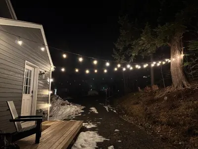 a string of lights hanging from a house at night at Private Chalet - 4 mins to Mt Snow in Dover