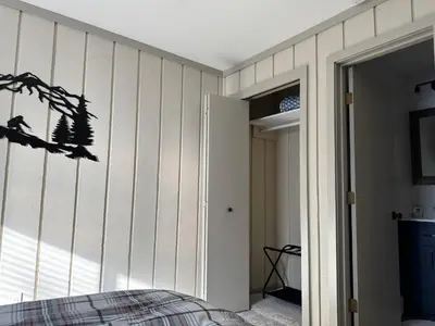 a bedroom with a bed and a wall at Private Chalet - 4 mins to Mt Snow in Dover