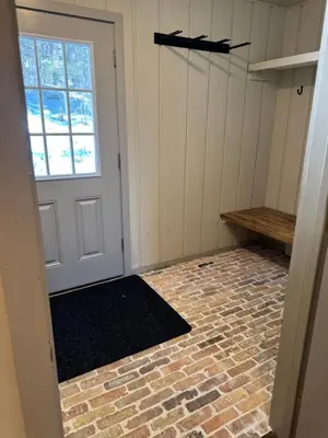 a room with a door and a brick floor at Private Chalet - 4 mins to Mt Snow in Dover