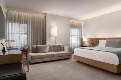 a hotel room with a bed and a couch at The Knickerbocker in New York