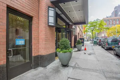 a building with a door on the side of a street at Blueground UWS gym elevator nr Central Park NYC-1443 in New York