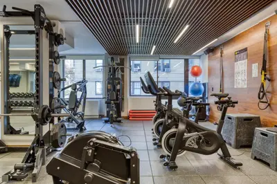 a gym with several treadmills and cardio machines at Blueground UWS gym elevator nr Central Park NYC-1443 in New York