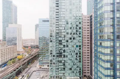 an aerial view of a tall building in a city at Blueground LIC gym balcony nr MoMA PS1 NYC-1659 in New York