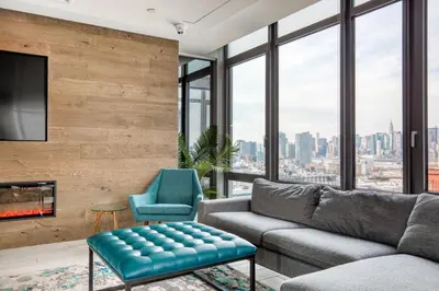 a living room with a couch and a fireplace at Blueground LIC gym balcony nr MoMA PS1 NYC-1659 in New York