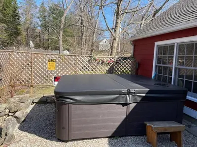 a large grill sitting outside of a house at The Hideaway in Brewster