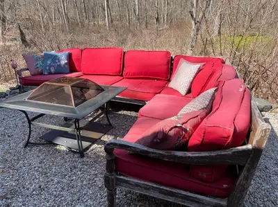a red couch sitting next to a table at The Hideaway in Brewster