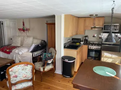 a kitchen and living room with a couch and a table at The Hideaway in Brewster