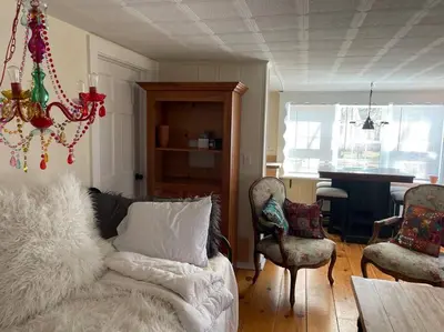 a living room with a couch and chairs and a table at The Hideaway in Brewster