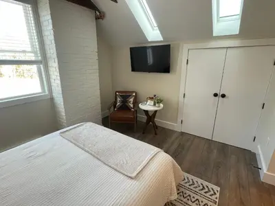 a bedroom with a bed and a tv on the wall at The Innwoods - Studio Apartment 1 in Tannersville
