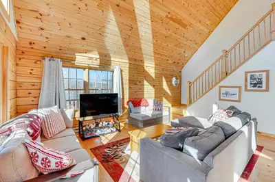 a living room with a couch and a tv at Brushridge Mountain House Ski, Hike and Fish in Fleischmanns