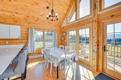 a dining room with a table and chairs and windows at Brushridge Mountain House Ski, Hike and Fish in Fleischmanns