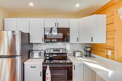 a kitchen with white cabinets and a stainless steel refrigerator at Brushridge Mountain House Ski, Hike and Fish in Fleischmanns