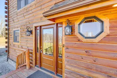 a wooden cabin with a door and a window at Brushridge Mountain House Ski, Hike and Fish in Fleischmanns