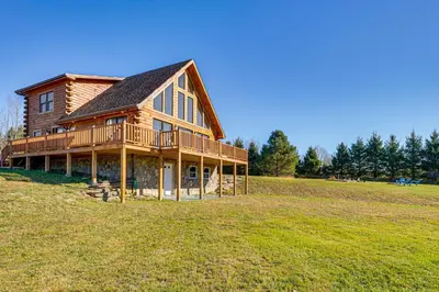 a large wooden house on top of a field at Brushridge Mountain House Ski, Hike and Fish in Fleischmanns