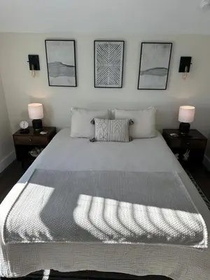 a bedroom with a large bed with two night stands at The Innwoods - Studio Apartment 2 in Tannersville