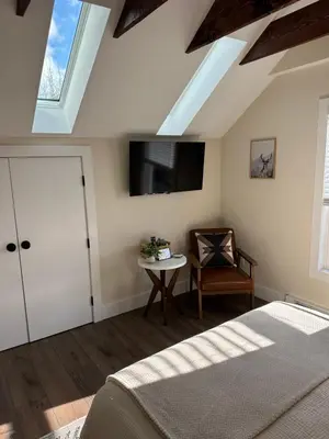 a bedroom with a bed and a table and a window at The Innwoods - Studio Apartment 2 in Tannersville