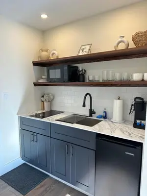 a kitchen with blue cabinets and a sink at The Innwoods - Studio Apartment 2 in Tannersville