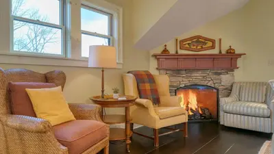 a living room with chairs and a fireplace at Catskill Park Farm by AvantStay Huge Yard Fire Pit Near Windham Ski Resort in Prattsville