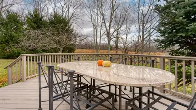 a table with two fruit on a wooden deck at Catskill Park Farm by AvantStay Huge Yard Fire Pit Near Windham Ski Resort in Prattsville