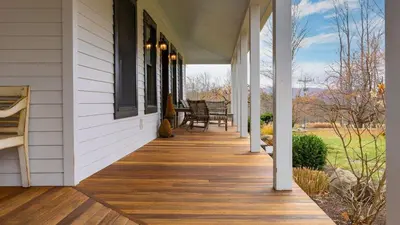 a front porch of a house with a wooden floor at Catskill Park Farm by AvantStay Huge Yard Fire Pit Near Windham Ski Resort in Prattsville