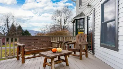 a wooden bench and fruit on a porch at Catskill Park Farm by AvantStay Huge Yard Fire Pit Near Windham Ski Resort in Prattsville
