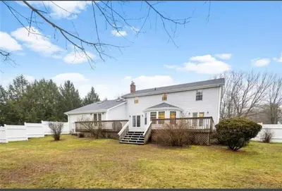a white house with a fence in a yard at Premium Private Suite with Parking and Workspace in South Windsor