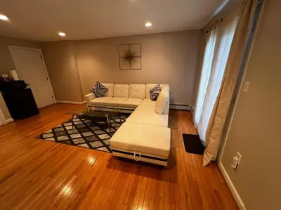 a living room with a couch and a table at Premium Private Suite with Parking and Workspace in South Windsor