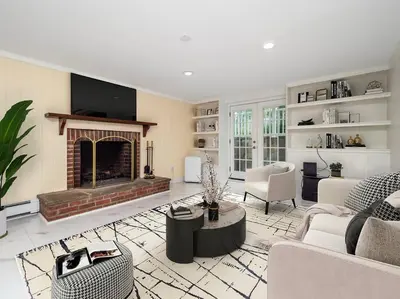 a living room with a fireplace and a couch at New Canaan's Downtown Retreat in New Canaan
