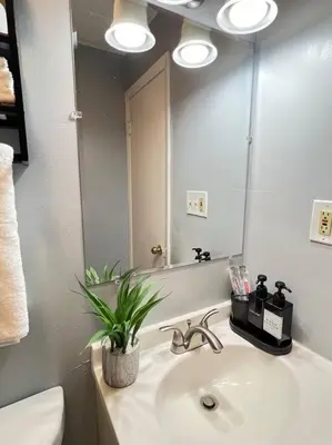 a bathroom with a sink and a mirror at Criscaris Homes in New Britain