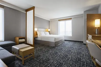 a hotel room with a bed and a couch at Hyatt Place New York Yonkers in Yonkers