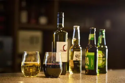 four bottles of wine and two glasses on a table at Hyatt Place New York Yonkers in Yonkers