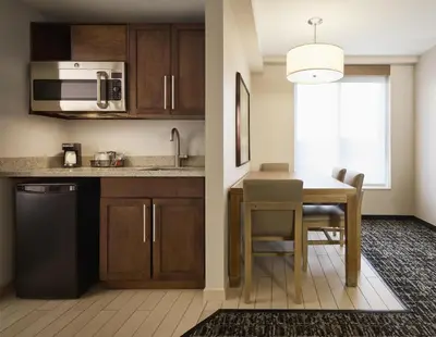 a kitchen with a table and a sink and a microwave at Hyatt Place New York Yonkers in Yonkers