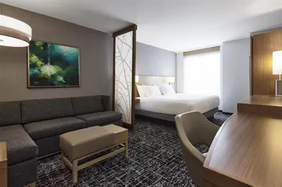 a hotel room with a couch and a bed at Hyatt Place New York Yonkers in Yonkers