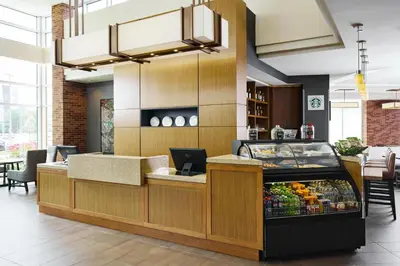 a restaurant with a checkout counter with a fruit display at Hyatt Place New York Yonkers in Yonkers
