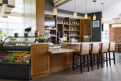 a restaurant with a bar with bar stools at Hyatt Place New York Yonkers in Yonkers