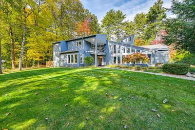 a large house with a large yard at 7 Mi to Skiing Lake George Home with Large Patio in Queensbury
