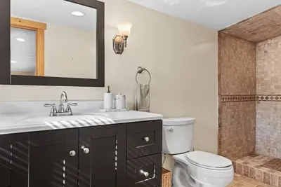 a bathroom with a sink and a toilet and a shower at New! 3BR Contemporary Log Home in Catskill Mtns in Margaretville