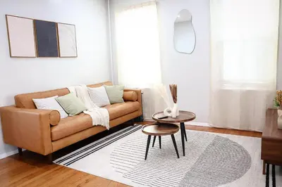 a living room with a couch and a table at Modern 2BR, Easy access to NYC in Jersey City