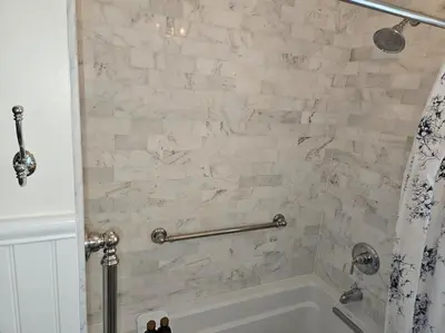 a bathroom with a white tub and a shower at Heart Historic Ridgefield Studio WALK to town in Ridgefield
