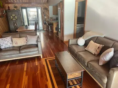 a living room with two leather couches and a table at Lake Moraine Home #7 Near Colgate University in Hamilton