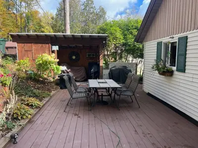 a patio with a table and chairs on a deck at Lake Moraine Home #7 Near Colgate University in Hamilton