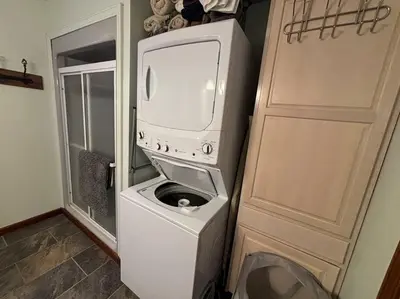 a washer and dryer in a room with a door at Lake Moraine Home #7 Near Colgate University in Hamilton