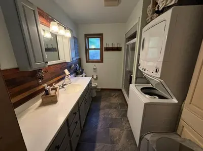 a bathroom with a sink and a washing machine at Lake Moraine Home #7 Near Colgate University in Hamilton