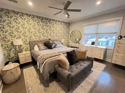 a bedroom with a bed and a couch and a window at Charles Peak Condo - JC Heights in Jersey City