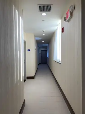 a hallway in a hospital with a long corridor at Voyage Hotel in Long Island City