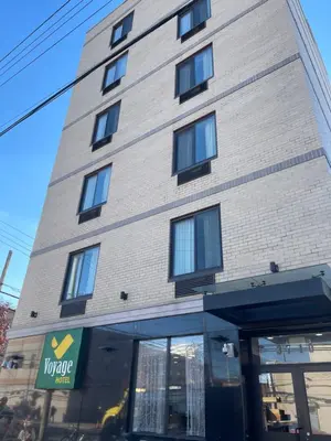 a tall building with windows on the side of it at Voyage Hotel in Long Island City