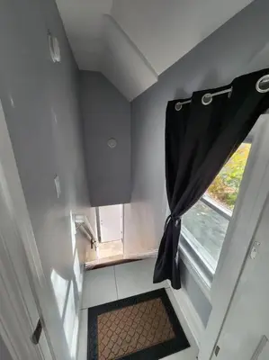 a room with a window and a curtain at Two-Bedroom Home 25 min to NYC free parking-UNIT-2 in Teaneck