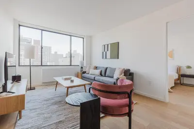 a living room with a couch and a table at Blueground Upper West Side nr parks wd NYC-1678 in New York