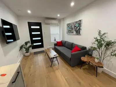 a living room with a couch and a table at Stunning Family Style Duplex in New York